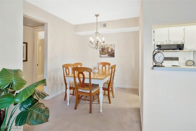 dining area featuring light colored carpet and a notable chandelier