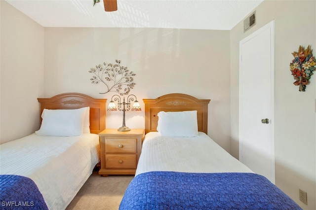 bedroom featuring light colored carpet and ceiling fan