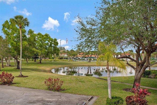 view of home's community with a lawn and a water view