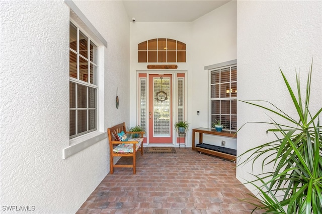 5683 Whispering Willow Way, Fort Myers, FL 33908 - view of exterior entry with stucco siding and a porch