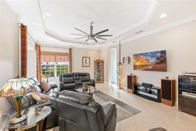 5683 Whispering Willow Way, Fort Myers, FL 33908 - living area with a tray ceiling, light tile patterned floors, arched walkways, ornamental molding, and ceiling fan