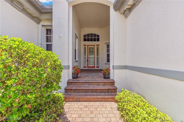 5683 Whispering Willow Way, Fort Myers, FL 33908 - doorway to property with stucco siding and covered porch
