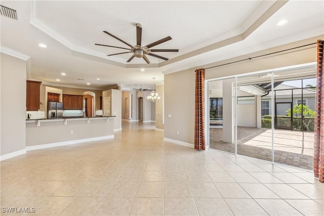 5683 Whispering Willow Way, Fort Myers, FL 33908 - unfurnished living room with a raised ceiling, ornamental molding, ceiling fan, recessed lighting, and light tile patterned flooring