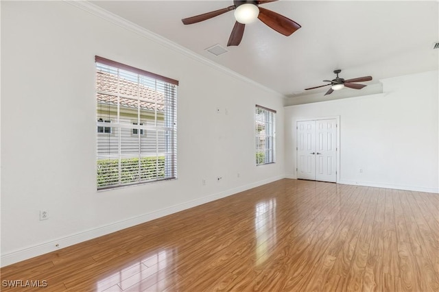 5683 Whispering Willow Way, Fort Myers, FL 33908 - empty room with ceiling fan, healthy amount of natural light, ornamental molding, and light wood-type flooring