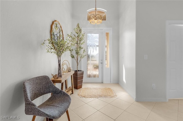 tiled entrance foyer with a healthy amount of sunlight and a notable chandelier