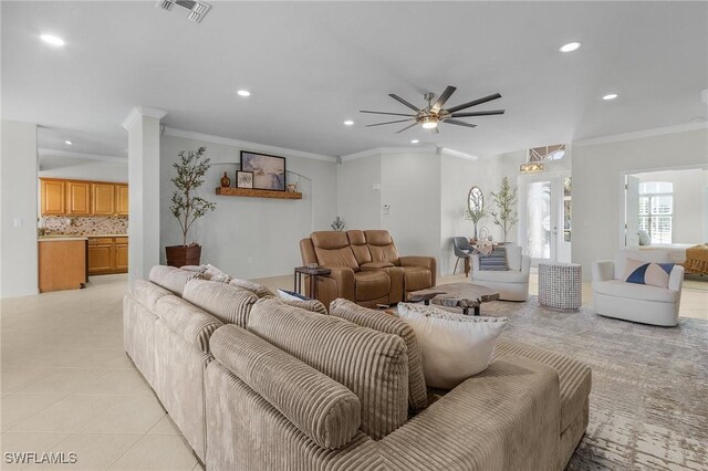 tiled living room with crown molding and ceiling fan