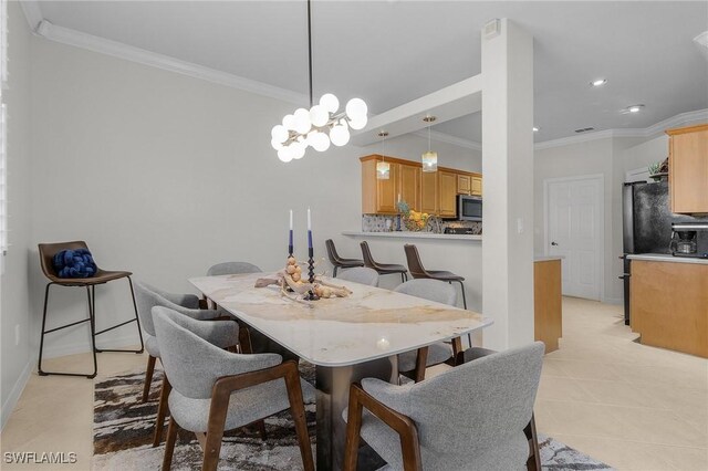 dining room with ornamental molding, light tile patterned floors, and a chandelier