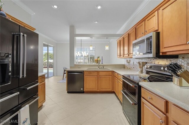 kitchen featuring pendant lighting, sink, crown molding, tasteful backsplash, and black appliances