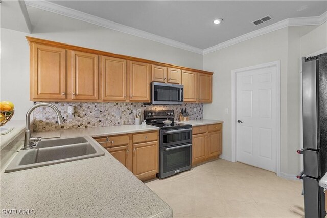 kitchen with sink, crown molding, light tile patterned floors, appliances with stainless steel finishes, and decorative backsplash