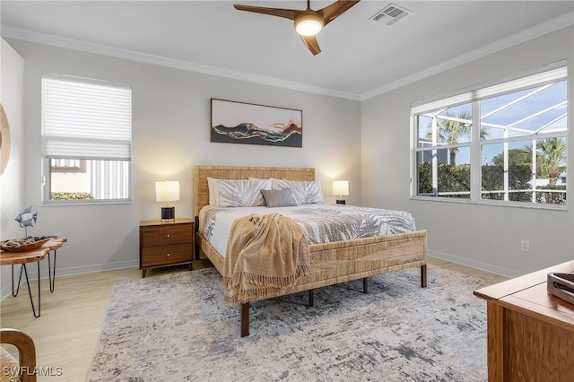 bedroom with crown molding, ceiling fan, and light hardwood / wood-style flooring