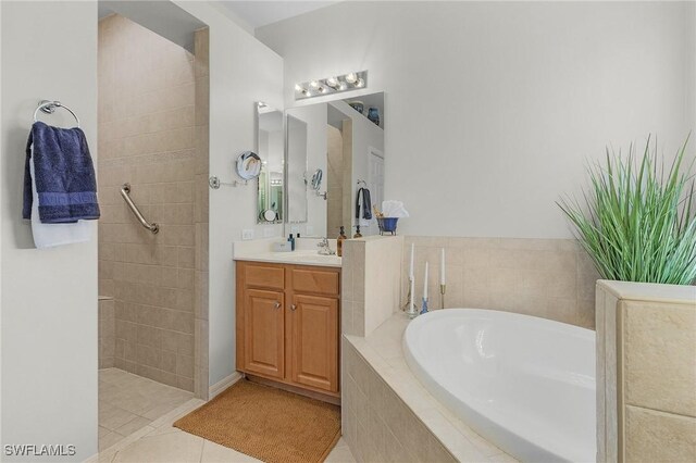 bathroom with tile patterned flooring, vanity, and shower with separate bathtub