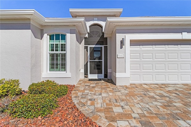 view of exterior entry featuring a garage