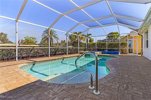 view of pool featuring a patio area and glass enclosure