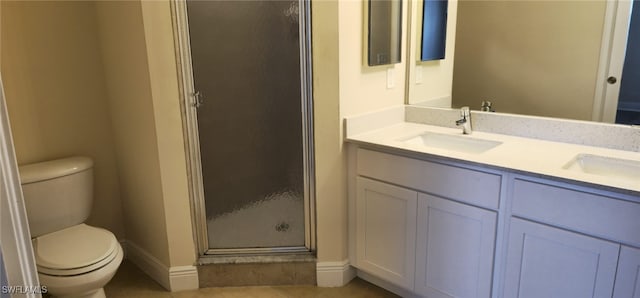 bathroom with vanity, toilet, tile patterned floors, and a shower with shower door