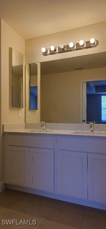 bathroom featuring tile patterned flooring and vanity