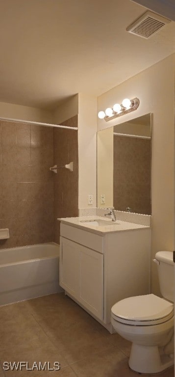 full bathroom with vanity, tiled shower / bath, tile patterned flooring, and toilet