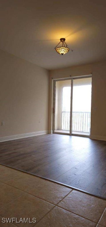 unfurnished room with wood-type flooring