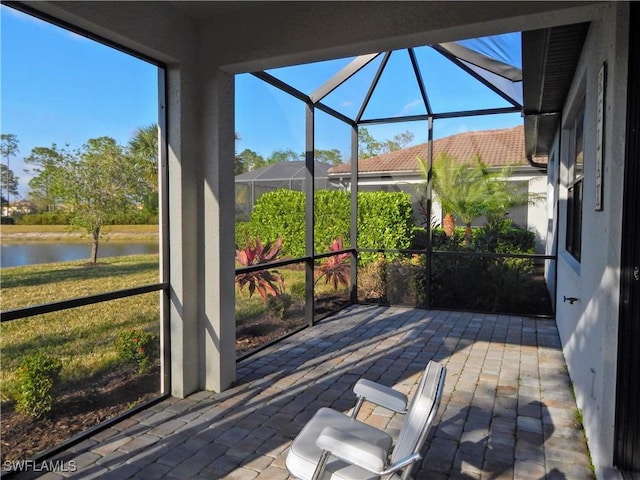 unfurnished sunroom featuring a water view