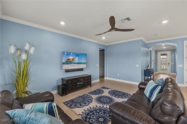 living room with crown molding, ceiling fan, and light hardwood / wood-style flooring