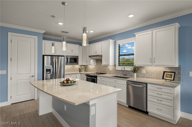 kitchen with white cabinetry, stainless steel appliances, a center island, and sink