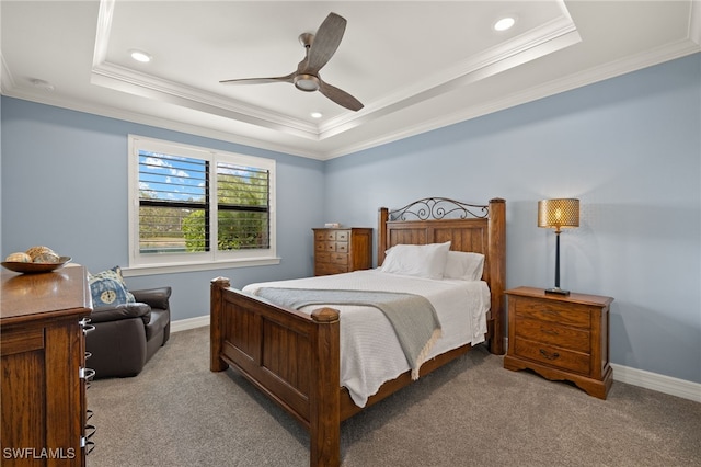 bedroom with a tray ceiling, ornamental molding, and light colored carpet