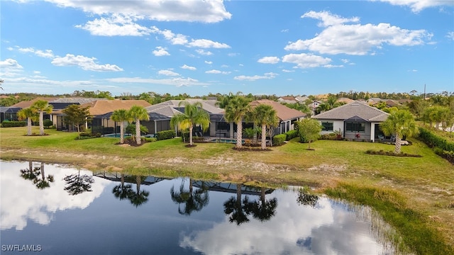 back of house featuring a lanai, a lawn, a gazebo, and a water view