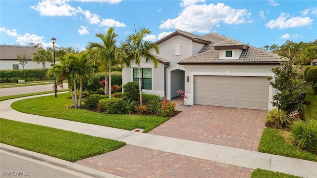 mediterranean / spanish-style house with a garage and a front lawn