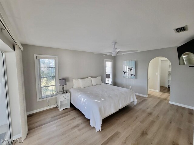 bedroom with ceiling fan and light wood-type flooring