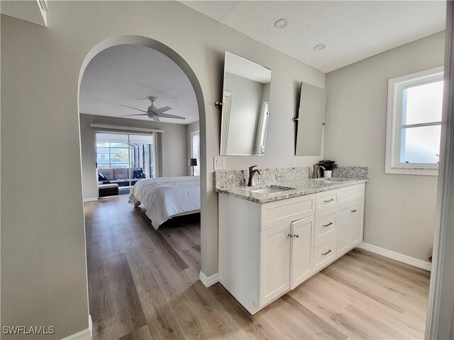 bathroom featuring ceiling fan, wood-type flooring, and vanity