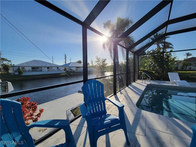 exterior space featuring a lanai and a water view