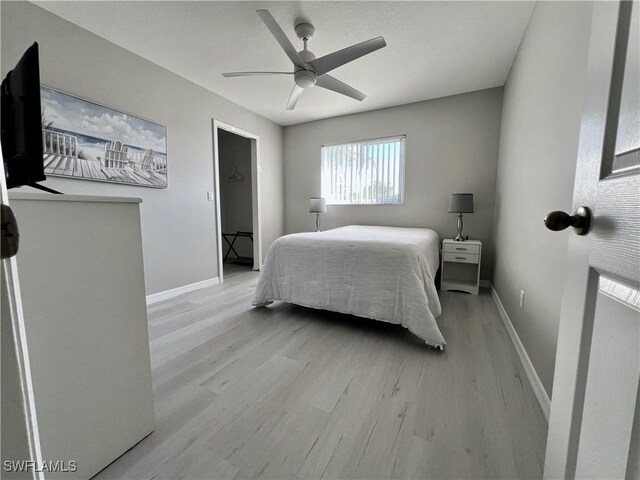 bedroom with ceiling fan and light hardwood / wood-style flooring