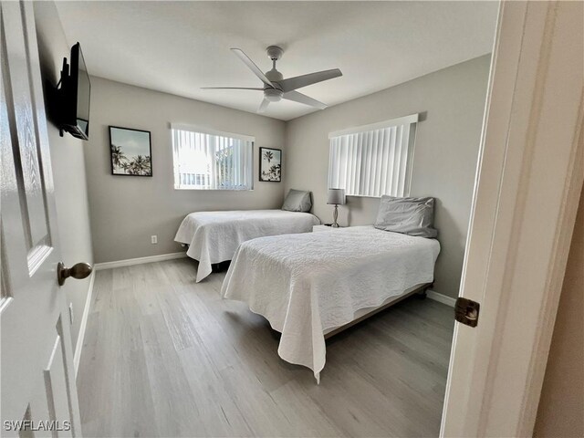 bedroom with ceiling fan and light wood-type flooring