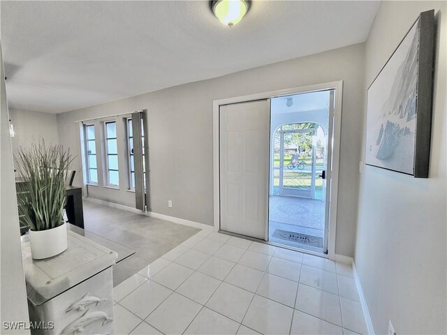 entryway featuring plenty of natural light and light tile patterned floors