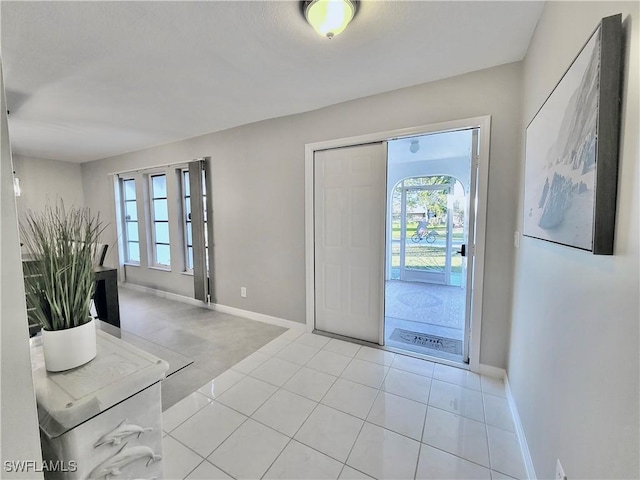 224 SW 47th St, Cape Coral, FL 33914 - foyer entrance featuring healthy amount of natural light, baseboards, and light tile patterned flooring