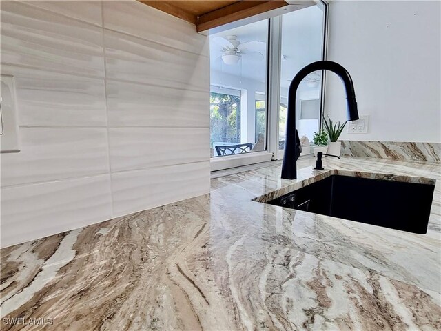 kitchen with appliances with stainless steel finishes, white cabinetry, decorative backsplash, light tile patterned floors, and light stone counters