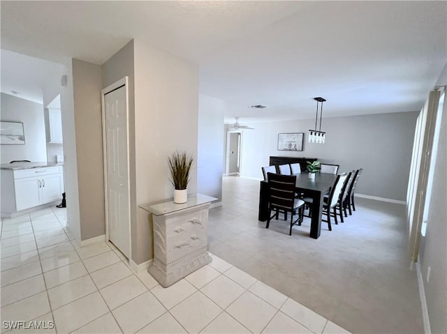 tiled dining room with ceiling fan