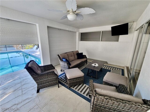 view of patio with an outdoor living space and ceiling fan