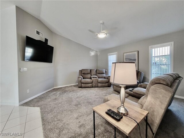 living room featuring light colored carpet, ceiling fan, and vaulted ceiling