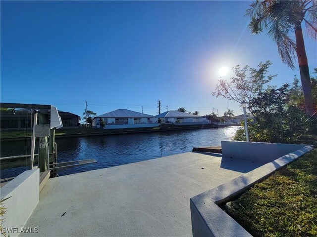 exterior space with a water view and a boat dock