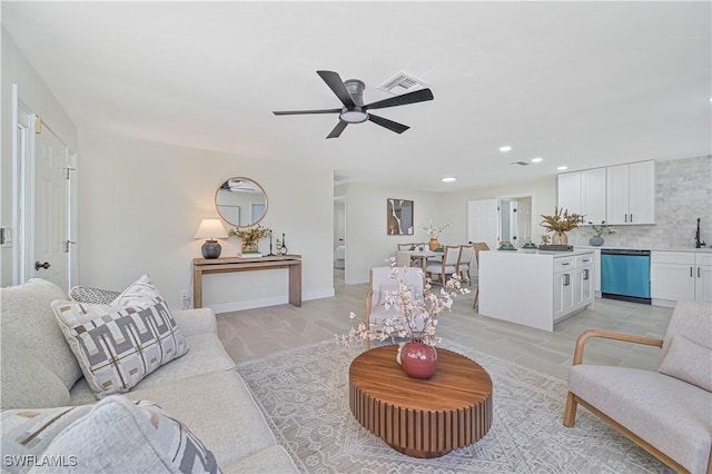 living room featuring sink and ceiling fan