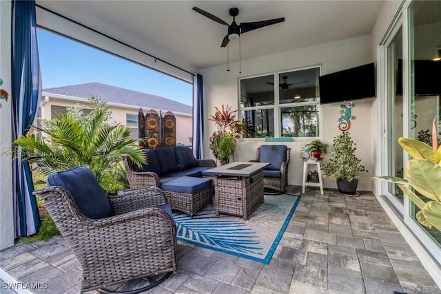 sunroom featuring ceiling fan