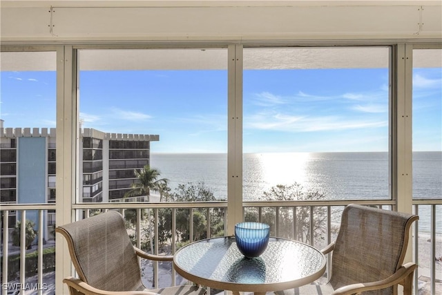 sunroom / solarium with a water view