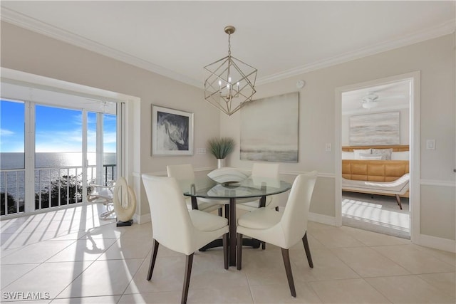 tiled dining area featuring crown molding, a water view, and an inviting chandelier