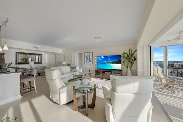 living room featuring crown molding, light tile patterned floors, and ceiling fan