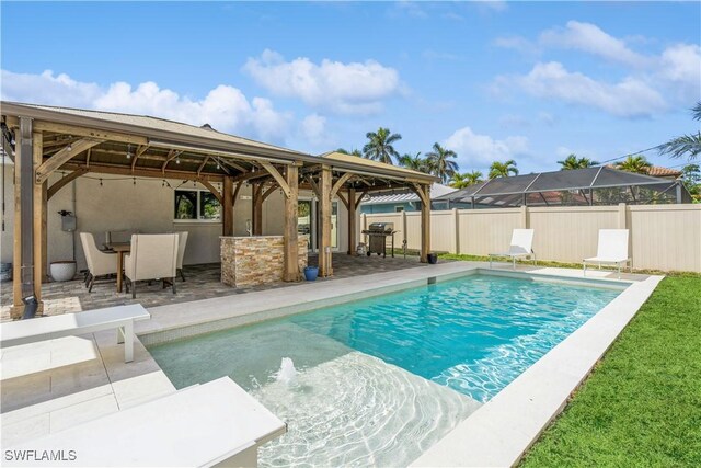 view of swimming pool with a patio, area for grilling, and an outdoor bar