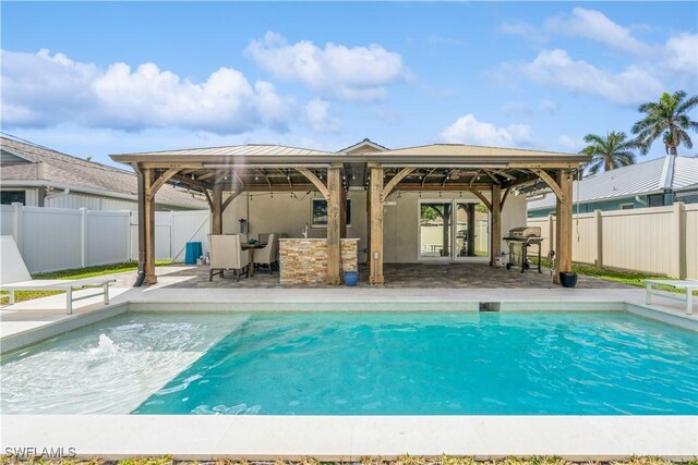 view of swimming pool featuring a gazebo, a grill, a patio, and a bar