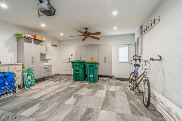 garage featuring a garage door opener and ceiling fan