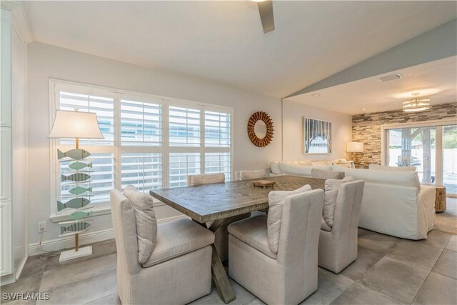 tiled dining area with vaulted ceiling