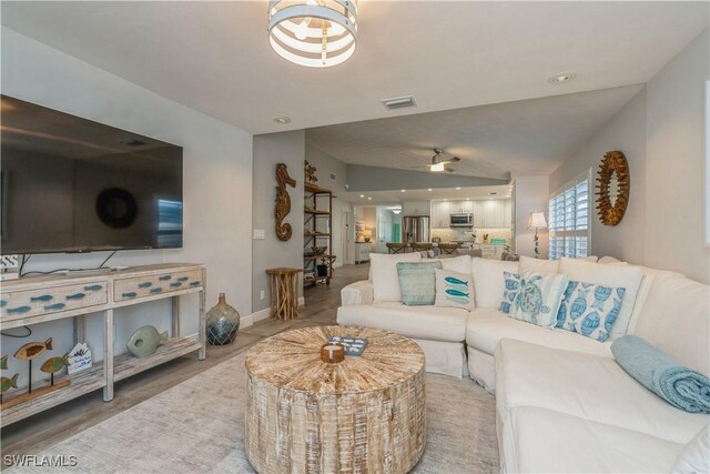 tiled living room with lofted ceiling