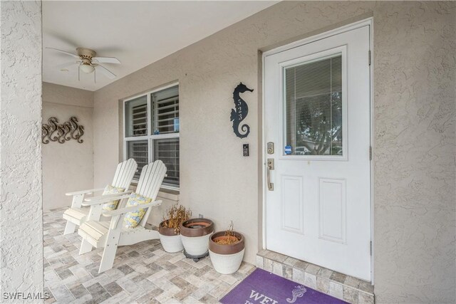 entrance to property with ceiling fan